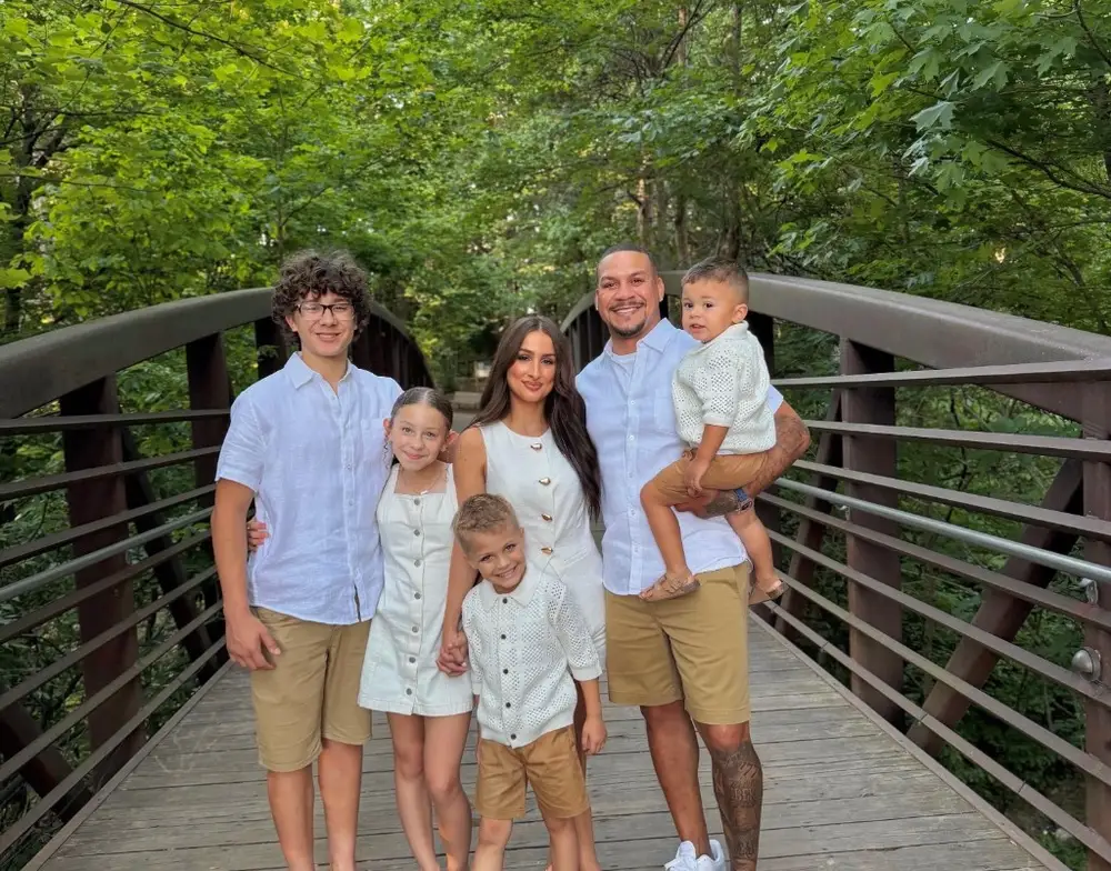 The AAP Superior Services family — owner, spouse, and children — together outdoors